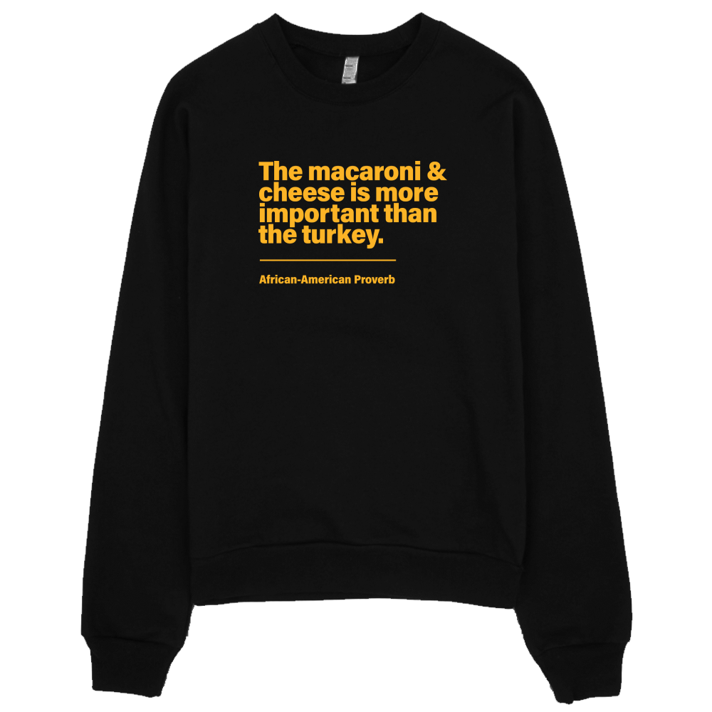 Sweatshirt with the words macaroni and cheese is more important than the turkey